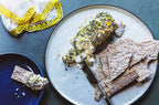 Plated dish with crackers and goat cheese spread using the Table Blend on a blue surface